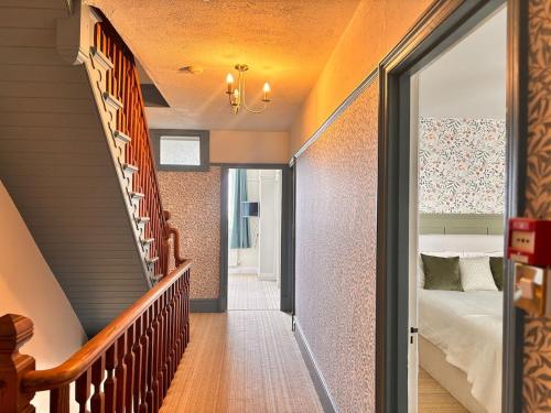 a hallway with a staircase leading to a bedroom at Lyme Regis Luxury Escape in Lyme Regis