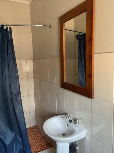 a bathroom with a sink and a mirror at Bothabelo Bed and Breakfast in Phalaborwa