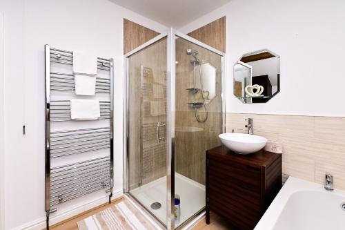 a bathroom with a shower and a sink at Cosy Mumbles Escape Fun & Relax in The Mumbles