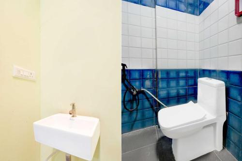 a bathroom with a toilet and a sink at Collection O Moula Ali Neredmet 