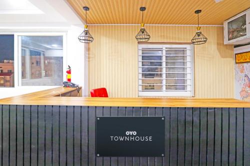 a counter at a town house with a sign on it at Super Townhouse QUALIA ELITE S R NAGAR in Hyderabad