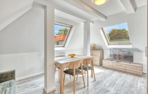 a dining room with white walls and a table and chairs at Gorgeous Apartment In Altenkirchen in Altenkirchen