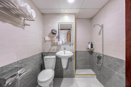 a bathroom with a toilet and a sink and a shower at A25 Hotel - 167 Phạm Ngũ Lão in Ho Chi Minh City