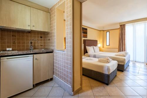 a hotel room with two beds and a kitchen at VONRESORT Golden Beach & Aqua - Kids Concept-Ultra All Inclusive in Side