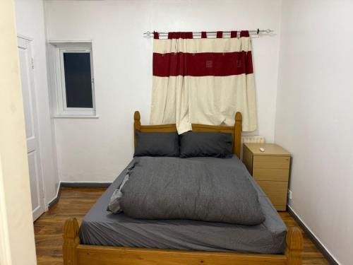 a bedroom with a bed with a curtain on it at Quiet & peaceful holiday home in Rainham