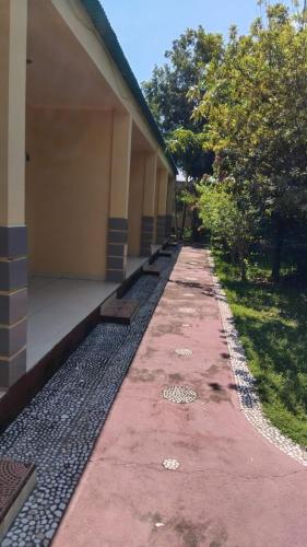 a long pathway next to a building at Hotel Wailiti in Maumere