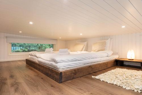 a large bed in a room with a large window at Åre Travel - Villa Solbringen eller Lilla Sol in Åre