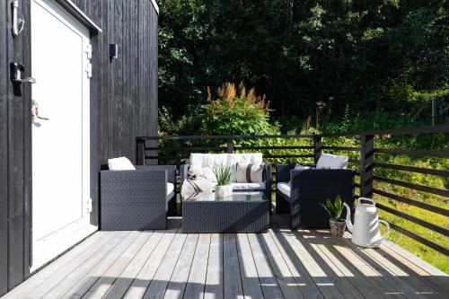 a patio with two couches on a wooden deck at Åre Travel - Villa Solbringen eller Lilla Sol in Åre