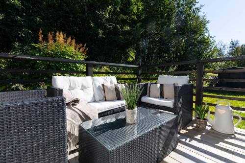 a patio with a couch and a table on a deck at Åre Travel - Villa Solbringen eller Lilla Sol in Åre