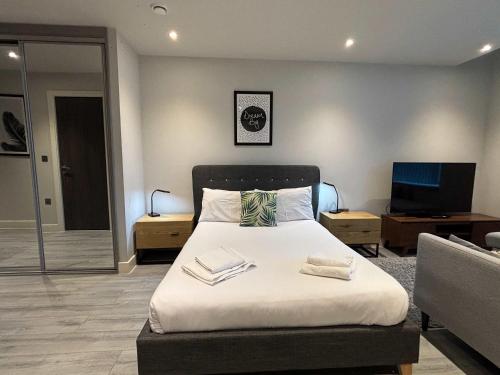 a bedroom with a bed with two books on it at Stylish Studio in Bracknell with free Parking in Bracknell