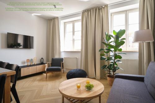 a living room with a couch and a table at Solny Square Aparthotel in Wrocław