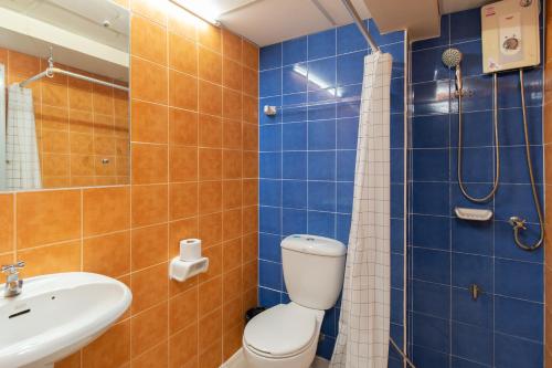 a bathroom with a toilet and a sink at Petch Tower Ekamai Budget Serviced Apartments in Bangkok