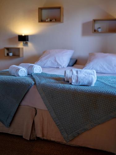 two towels are sitting on top of a bed at Chalet LE VAL NESS in La Côte dʼArbroz