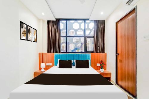a bedroom with a large bed and a window at Collection O Mahakal Temple in Ujjain