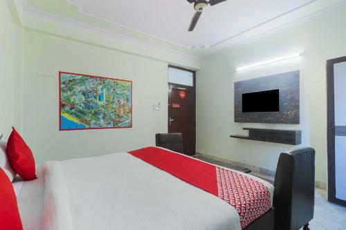 a bedroom with a bed and a flat screen tv at Hotel O Jaipur Railway Junction Vijeet Palace in Jaipur