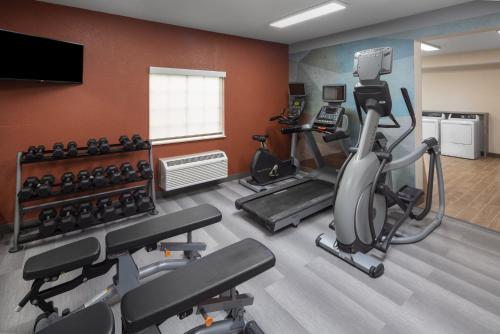a gym with cardio equipment in a room at Candlewood Suites St. Robert by IHG in Saint Robert