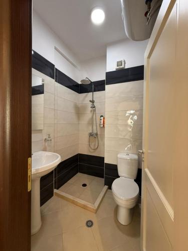 a bathroom with a toilet and a sink at Oasis Bay Lalzi in Lalzit Bay