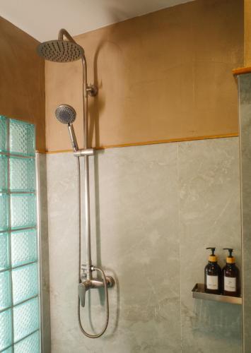 a shower with a shower head in a bathroom at Salty Pearl Phuket 1 in Patong Beach