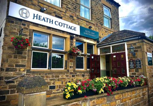 a health center with flowers in front of a building at Heath Cottage Hotel in Dewsbury