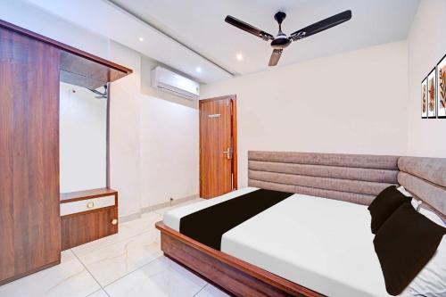a bedroom with a bed and a window at Collection O LIG Main Road Indore in Indore