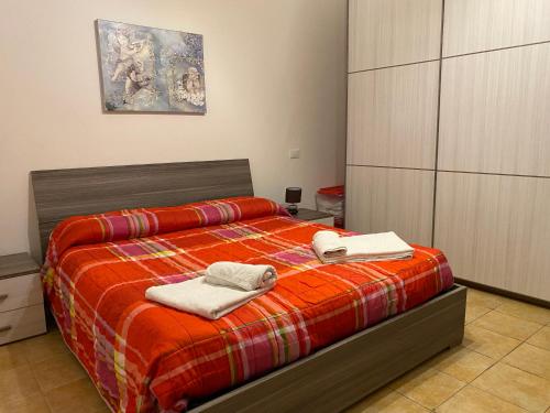 a bedroom with a bed with two towels on it at Casa Giulia near Lazise, Garda lake and Gardaland in Lazise