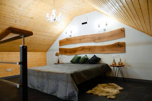 a bedroom with a bed with a wooden wall at Заміський комплекс Lisovi Polyany 
