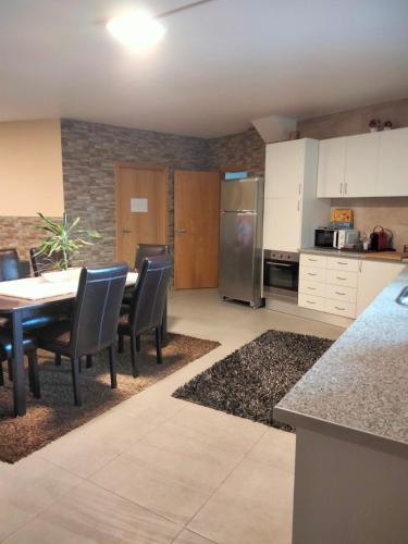 a kitchen and dining room with a table and chairs at Casa Moderna na Aldeia in Marco de Canaveses