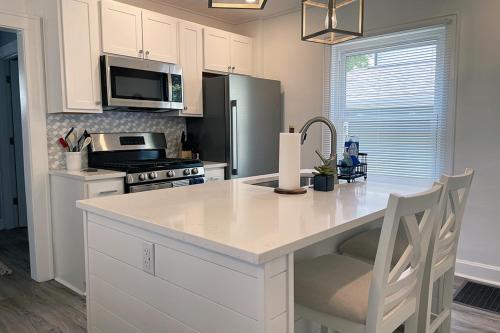 a kitchen with a white counter top and a refrigerator at Cozy Campbell Bungalow in Columbus