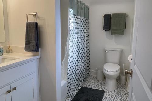 a bathroom with a toilet and a shower at Cozy Campbell Bungalow in Columbus