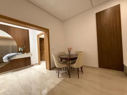 a dining room with a table and chairs at Luxus Apartment in Zarzis