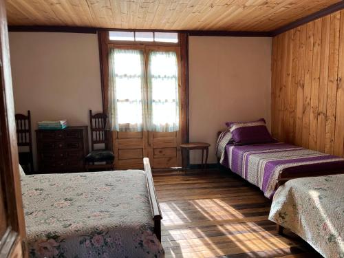 Letto o letti in una camera di Hostal Casa Rosada, Valle del Elqui