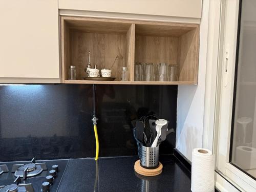 a kitchen with a counter top with a sink and a cabinet at Luxus Apartment in Zarzis