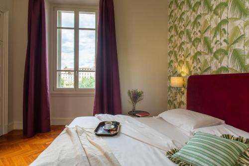 a bedroom with a bed with a tray of food on it at Serristori Palace Residence in Florence