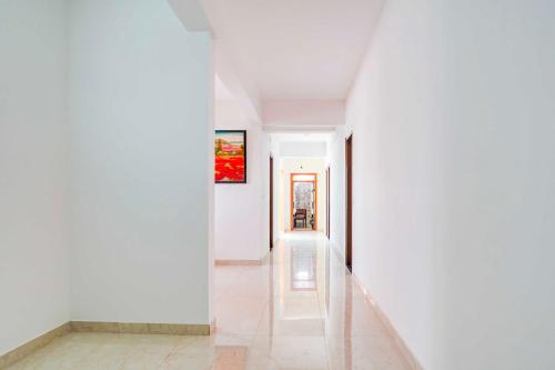 a hallway of a house with white walls at Collection O Hebbal Dasarahalli in Bengaluru