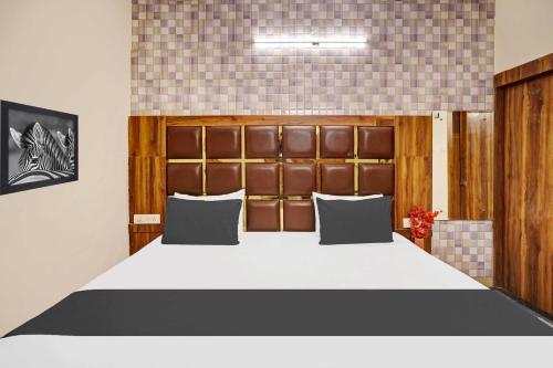 a bedroom with a large bed in a room at Hotel O Jammu Road in Katra