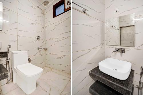 a white bathroom with a toilet and a sink at Hotel O Jammu Road in Katra