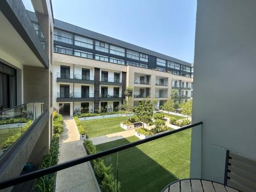 an external view of a building with a courtyard at APARTMENTS GH - Accra - Cantonments - Embassy Gardens in Accra