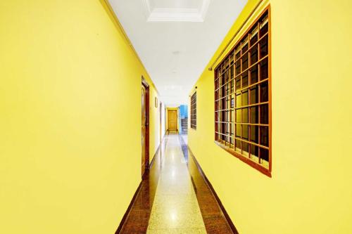 an empty hallway of a building with yellow walls at Collection O Padmavathi Puram Near Railway Station in Tirupati