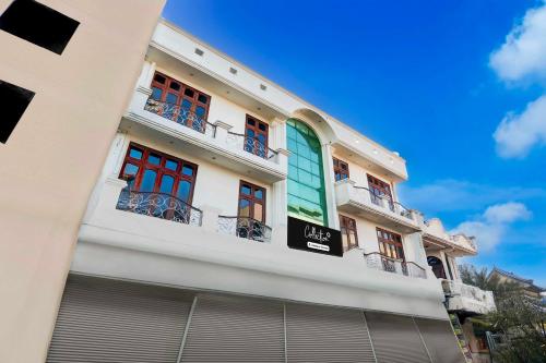 a white building with red and green windows at Collection O Subhani Building in Ludhiana