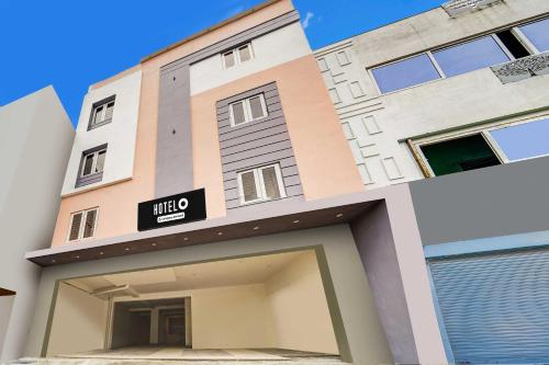 a building with a hilto sign on it at Hotel O RS Puram North Railway Station RG Residency in Coimbatore