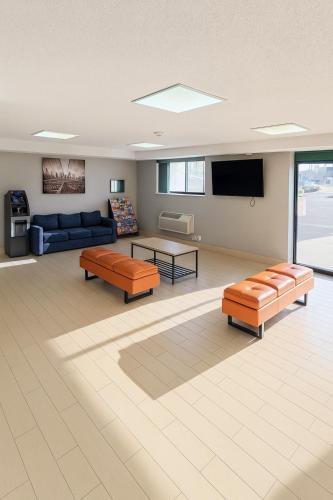 a living room with two couches and a tv at Floral Park Motor Lodge in Floral Park