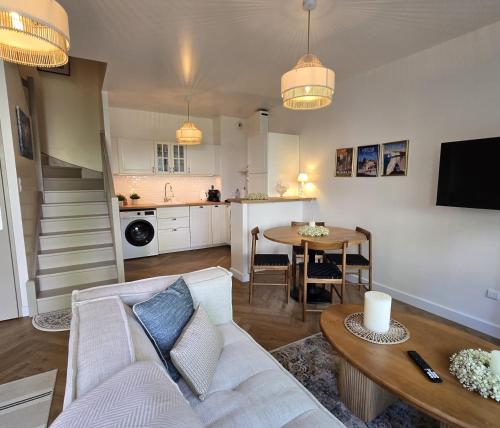 a living room with a couch and a table at Agnes Little Corner in Honfleur