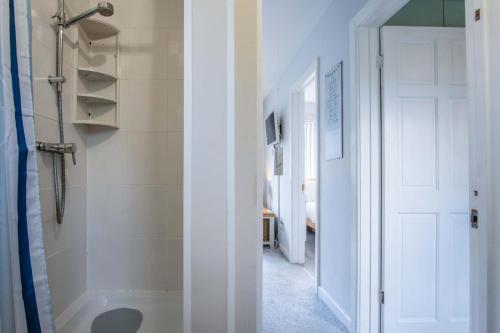 a bathroom with a tub and a walk in shower at Langcliffe Park - 2 Bedroom Chalet - Mumbles in The Mumbles