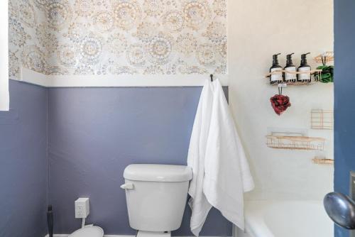 a bathroom with a white toilet and a shower at The University Retreat in Tucson