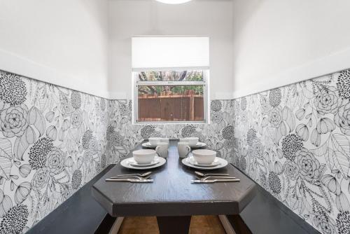 a dining room table with a black and white patterned wall at The University Retreat in Tucson