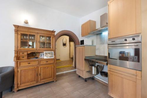 a kitchen with wooden cabinets and a counter top at Ferienhaus alte Münze in Neuerburg