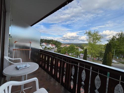 a balcony with a table and chairs and a view at Simplex Stays Hotel Lauer in Bad Soden-Salmünster