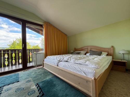 a bedroom with a bed and a large window at Simplex Stays Hotel Lauer in Bad Soden-Salmünster