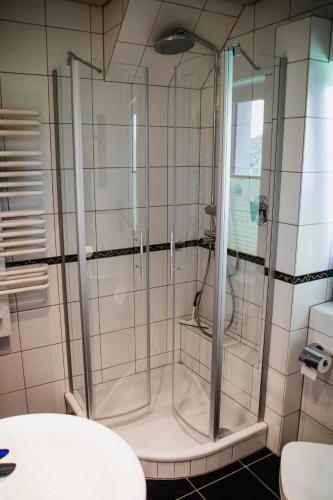 a shower with a glass door in a bathroom at Ferienwohnung mit toller Aussicht in Sundern