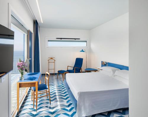 a bedroom with a bed and a table and chairs at Parco dei Principi in Sorrento